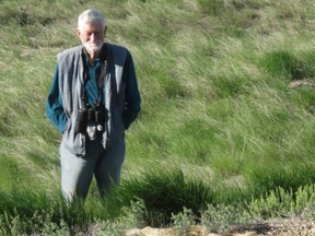 Gus Yaki viewing a prairie rattlesnake near the Onefour Heritage Rangeland Natural Area (photo credit Ann Lawson)