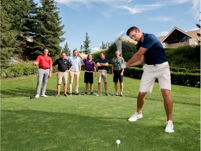 Brett Hogan practices his swing for a portrait as members of his team, The Worms, heckle him from the sidelines at the Glencoe Golf and Country Club in Calgary on Friday, July 28, 2017. (Photo by Yasmin Mayne)