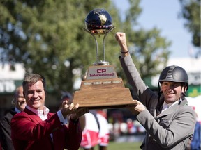 Keith Creel, left, CEO of Canadian Pacific presents Phillip Weishaupt of Germany with the CP International trophy at Spruce meadows in Calgary, on Sunday September 10, 2017. Leah Hennel/Postmedia

POSTMEDIA CALGARY  SPRUCE MEADOWS
Leah Hennel, Leah Hennel/Postmedia