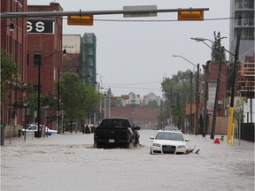 Downtown Calgary stands flooded with rising waters from torrential rain and swollen rivers in Calgary, Alberta, Canada,  June 21, 2013.   Flooding forced the evacuation of some 100,000 people in the western city of Calgary and nearby towns in the heart of the Canadian oil patch.   AFP PHOTO / DAVE BUSTONDAVE BUSTON/AFP/Getty Images

TOPSHOTS
DAVE BUSTON, AFP/Getty Images