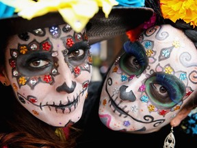 Girls paint their faces like La Catrina for Day of the Dead in Hidalgo, Mexico.