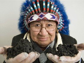 Chief Al Lameman of the Beaver Lake Cree Nation holds some oilsands.