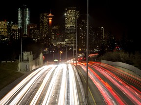 Traffic streams down Macleod Trail near the skyline of downtown Calgary.