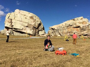 Dr. Peter Dawson with his son, Liam, scanning the Okotok's Erratic. Photo courtesy of Peter Dawson.