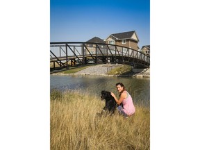 Becky Best and her four-legged friend Zeus along the canals in the community of Bayview by Genesis Land in Airdrie. The Bests bought a home here through Stepper Homes,