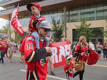 The Calgary Flames' Matt Stajan carries his son Elliot on his shoulder as he and other team members take part in the Calgary Pride Parade on Sunday September 3, 2017.