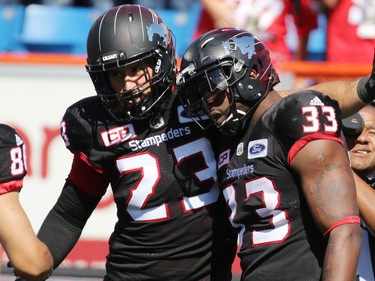 Calgary Stampeders running back Jerome Messam, right, is congratulated by teammate William Langlois after running in a touch down during the second half of the Labour Day Classic at McMahon Stadium, Monday September 4, 2017. The Stamps won 39-18.