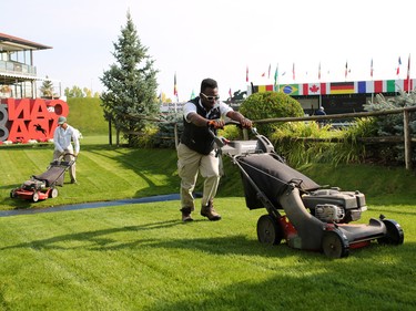 Course workers make a final cut of the grass in the International Ring at Spruce Meadows Masters on Tuesday September 5, 2017. Competition in the Spruce Meadows Masters begins Wednesday.