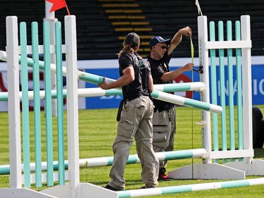 Course workers set up jumps in the International Ring for the Spruce Meadows Masters on Tuesday September 5, 2017. Competition begins Wednesday.
