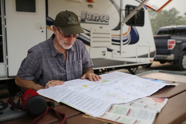 Francois Camirand from Quebec looks at his camping options in the nearly empty Waterton townsite campground  on Wednesday September 6, 2017. The town is currently under a voluntary evacuation order that could be changed to a mandatory order with 1 hours notice. A large wildfire is on the edge of Waterton National Park and threatens the town.