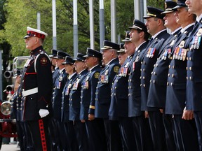 Calgary firefighters stand at attention during the Firefighters Memorial Ceremony at City Hall on Tuesday September 12, 2017.  Gavin Young/Postmedia