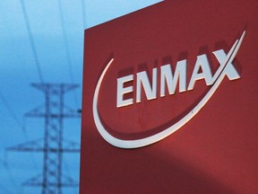 Powerlines rise behind an Enmax sign at the company's head office in Calgary. Gavin Young/Calgary Herald (For City section story by ) Trax# --- Begin Additional Info --- Enmax sign ORG XMIT: POS2014111917372986
Postmedia