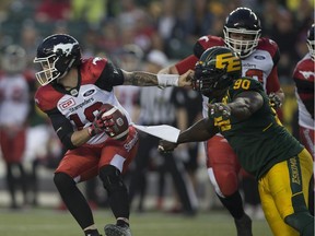 Edmonton Eskimos Almondo Sewell (90) reaches for Calgary Stampeders quarterback Bo Levi Mitchell (19) on Saturday September 9, 2017 in Edmonton.  Greg  Southam / Postmedia
Greg Southam, Postmedia