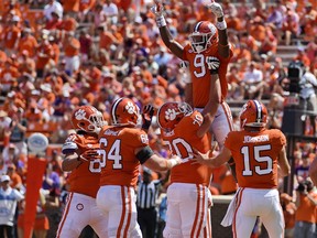 Clemson's Travis Etienne (9) celebrates his fourth quarter touchdown with teammates during the second half of an NCAA college football game against Kent State Saturday, Sept. 2, 2017, in Clemson, S.C. Clemson won 56-3.