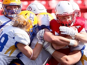 The Calgary Colts' Brandon MacIsaac makes a catch in front of Saskatoon Hilltops, James Vause during game action at McMahon Stadium in Calgary on Sunday, September 17, 2017.