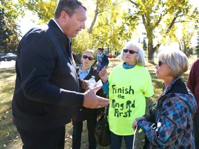 Calgary Mayor candidate Bill Smith (L) chats with Calgarians in Haysboro on Sunday, September 24, 2017. Smith was joined by concerned SW residents and the group ready to engage! to discuss the SWBRT fast track issue. Jim Wells/Postmedia