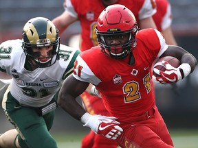 University of Calgary running back #21 Jeshrun Antwi finds an open seam as Regina Rams #31 Cord Delinte attempts to bring him down during Canada West football action Friday night at McMahon Stadium  in Calgary.  Photo by David Moll, U of C Dinos