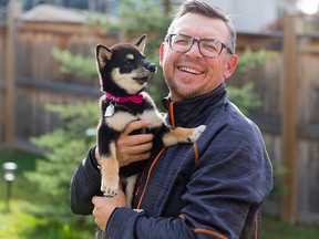 Former Flame Theo Fleury poses with his new dog, Kokoro, at his Calgary home.