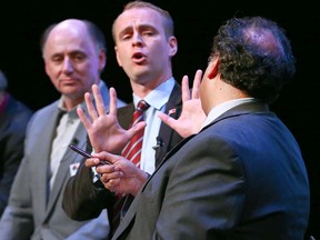 David Lapp (centre) and Naheed Nenshi trade opinions at a forum Wednesday night.
