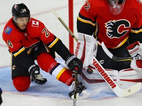 Calgary Flames defenceman Travis Hamonic and goaltender Jon Gillies keep the puck out of the net after a shot by Drake Gaggiula of the Edmonton Oilers during NHL pre-season hockey at the Scotiabank Saddledome in Calgary on Monday, September 18, 2017. Al Charest/Postmedia