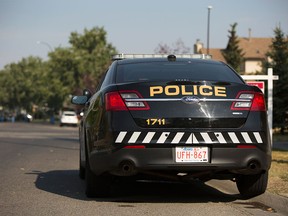 A police car outside a northwest home as Calgary police investigated after a man was found dead in a home in the 200 block of Hawkwood Boulevard northwest on Friday, Sept. 1, 2017 in Calgary, Alta.