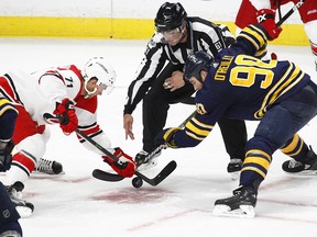 Buffalo Sabres Ryan O'Reilly (90) and Carolina Hurricanes Lucas Wallmark (71) take the faceoff during the second period of a preseason NHL hockey game, Monday Sept. 18, 2017, in Buffalo, N.Y. (AP Photo/Jeffrey T. Barnes)