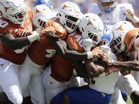 Tyler Nevens of the San Jose State Spartans is tackled by a gang of Texas Longhorns in the second quarter at Darrell K Royal-Texas Memorial Stadium on Sept. 9, 2017 in Austin, Texas.