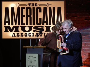 Iris DeMent hugs John Prine after Prine presented her with the lifetime achievement trailblazer award during the Americana Honors and Awards show Wednesday, Sept. 13, 2017, in Nashville, Tenn.