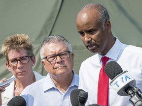 Ahmed Hussen, right, Minister of Immigration, Refugees and Citizenship, Ralph Goodale, Minister of Public Safety and Emergency Preparedness, and Brenda Shanahan, MP for Chateauguay-Lacolle on August 21, 2017 near Saint-Bernard-de-Lacolle, Que.
