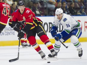 Calgary Flames Mark Jankowski makes a pass while being chased down by Vancouver Canucks Jakob Stukel (34) during NHL preseason hockey action at the Young Stars Classic held at the South Okanagan Events Centre in Penticton, BC, September, 10, 2017.
