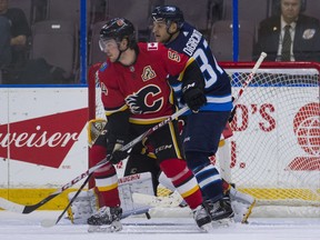 Calgary Flames Rasmus Andersson (left) battles against Winnipeg Jets Cristiano DiGiacinto while in front of his net during NHL preseason hockey action at the Young Stars Classic held at the South Okanagan Events Centre in Penticton, BC, September, 11, 2017.