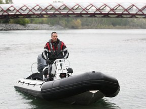 Calgary Police Cst Doug Sherwood launches the CPS Marine Unit boat on the Bow River in Calgary, Alta on Thursday May 14, 2015. Jim Wells/Calgary Sun/Postmedia Network