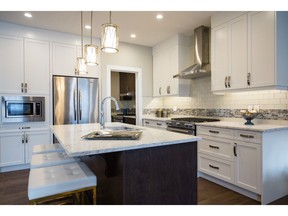 The kitchen in the Sage show home by Arcuri Homes in Savanna in Saddle Ridge.