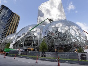 Construction continues on three large, glass-covered domes as part of an expansion of the Amazon.com campus, Thursday, April 27, 2017, in downtown Seattle. The tallest of the three interconnected spheres, called Amazon Spheres by the company, will be 90 feet high and 130 feet in diameter, and is planned to include a botanic garden of waterfalls and treehouse-like spaces overlooking tropical gardens. The structures are expected to begin being used by employees in early 2018. (AP Photo/Elaine Thompson) ORG XMIT: WAET201

STAND ALONE PHOTO
Elaine Thompson, AP