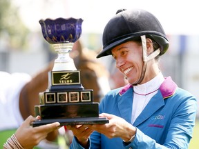 Rider, Luciana Diniz, riding Fit For Fun 13 recieves the TELUS Cup from Mimmi Kanji, Director of TELUS WISE as she won the competition at the Spruce Meadows Masters in Calgary on Wednesday, September 6, 2017. Darren Makowichuk/Postmedia