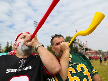 Stampeders fan Trent Petrich and Eskimos fan Trevor Barr have a noisy "horn off" before the start of the Labour Day Classic at McMahon Stadium on Monday September 4, 2017. Gavin Young/Postmedia