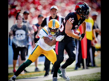 Calgary Stampeders Anthony Parker is tackled by Marcell Young of the Edmonton Eskimos during CFL football on Monday, September 4, 2017. Al Charest/Postmedia