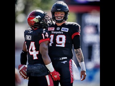 Calgary Stampeders Roy Finch and quarterback Bo Levi Mitchell celebrate after a two-point convert against the Edmonton Eskimos during CFL football on Monday, September 4, 2017. Al Charest/Postmedia