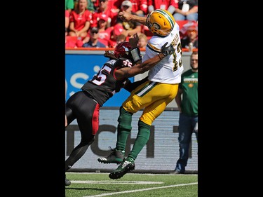 The Calgary Stampeders' Shaquille Richardson tackles Edmonton Eskimos quarterback Mike Reilly during the first half of the Labour Day Classic at McMahon Stadium, Monday September 4, 2017. Gavin Young/Postmedia