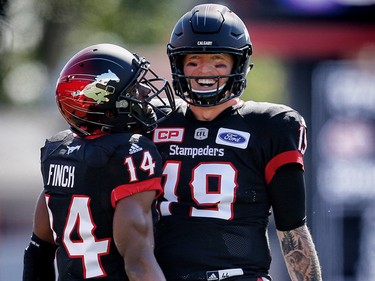 Calgary Stampeders Roy Finch and quarterback Bo Levi Mitchell celebrate after a two-point convert against the Edmonton Eskimos during CFL football on Monday, September 4, 2017.