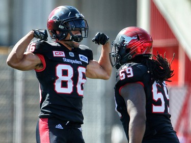 Calgary Stampeders Anthony Parker celebrates with teammate Randy Richards after his touchdown against the Edmonton Eskimos during CFL football on Monday, September 4, 2017.