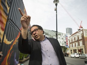 Mayor Naheed Nenshi speaks on the corner of 8th Avenue and 4th Street southeast as he gives columnist Val Fortney the rundown of his vision for an overhaul of East Village and Victoria Park area for a sport and entertainment district on Sunday, September 10, 2017 in Calgary, Alta. Britton Ledingham/Postmedia Network