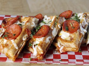 Nick Schmitt, Executive Chef at Roosevelt on 17 Ave SW displays his creation — a pepperoni pizza stuffed waffle in Calgary on Saturday, September 23, 2017. He invented the plate for the restaurant for YYC Pizza Week. Jim Wells/Postmedia