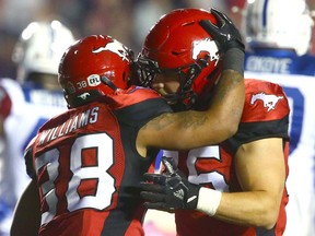 The Stamps' Terry Williams (L) celebrates a TD with teammate Rob Cote during CFL action between the Montreal Alouettes and the Calgary Stampeders in Calgary on Friday, September 29, 2017. Jim Wells/Postmedia