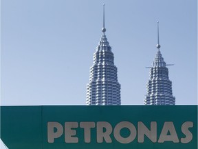 A Petronas gas station signage is pictured against Malaysia's landmark building, Petronas Twin Towers in Kuala Lumpur, Malaysia, Wednesday, March 2, 2016. National oil company Petroliam Nasional Bhd (Petronas) Tuesday, announced a layoff of almost 1,000 staff. (AP Photo/Joshua Paul) ORG XMIT: XJP102

STAND ALONE
Joshua Paul, AP