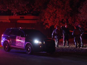 Police at the scene of a stabbing at Bearberry  Cres. NW in Calgary on Friday October 6, 2017. Leah Hennel/Postmedia