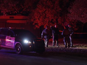 Police at the scene of a stabbing at Bearberry  Cres. NW in Calgary on Friday October 6, 2017. Leah Hennel/Postmedia