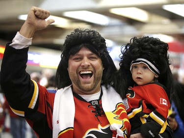 Calgary Flames fan Josh Bellemore and one year old son Kaden sport Jagr wigs before the team takes on the Winnipeg Jets in NHL hockey action at the Scotiabank Saddledome in Calgary on Saturday October 7, 2017. Leah Hennel/Postmedia