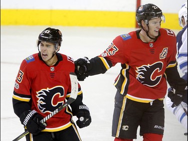 Calgary Flames Johnny Gaudreau, left, and Sean Monahan celebrate a goal on Winnipeg Jets in NHL hockey action at the Scotiabank Saddledome in Calgary on Saturday October 7, 2017. Leah Hennel/Postmedia