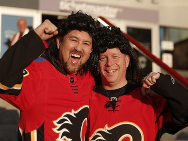 Calgary Flames fans Mike Yuen, left and Sean Vosburgh sport Jagr wigs before the team takes on the Winnipeg Jets in NHL hockey action at the Scotiabank Saddledome in Calgary on Saturday October 7, 2017. Leah Hennel/Postmedia